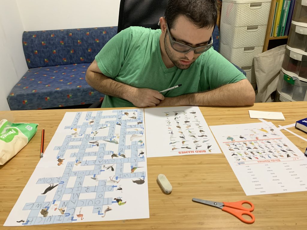 Tournament crossword puzzle grid with intersecting clues and rapid handwriting