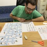 Tournament crossword puzzle grid with intersecting clues and rapid handwriting